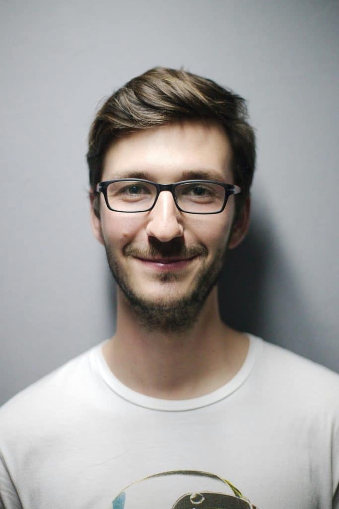 Confident charismatic man in everyday setting — the third path between MGTOW withdrawal and pickup artist tricks is becoming the kind of man women orbit by becoming genuinely interesting